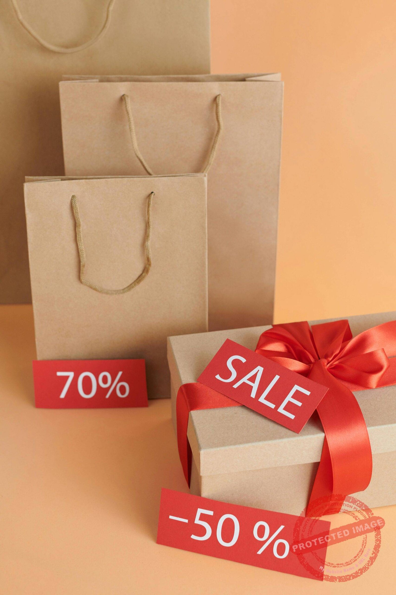 Elegant cardboard gift and shopping bags showcasing sale offers.